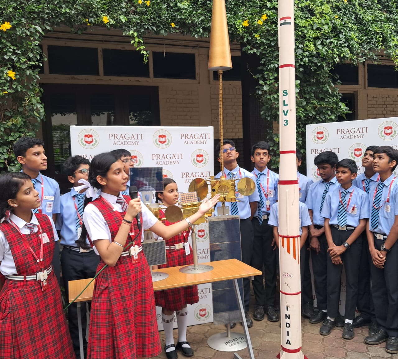 Students with satellite and rocket models — space science at Pragati Academy